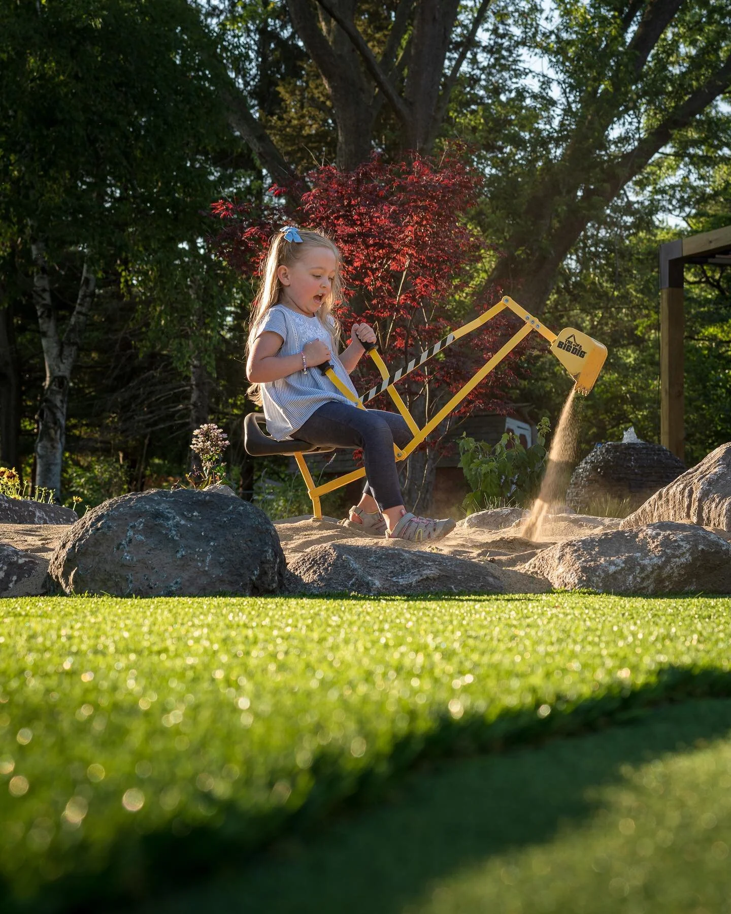 Don&rsquo;t forget about the kids when designing your backyard space. A simple sand area and a synthetic turf area for the playground is perfect! The sand area also doubles as the sand bunker for the nearby putting green! If the kids are happy, mama 