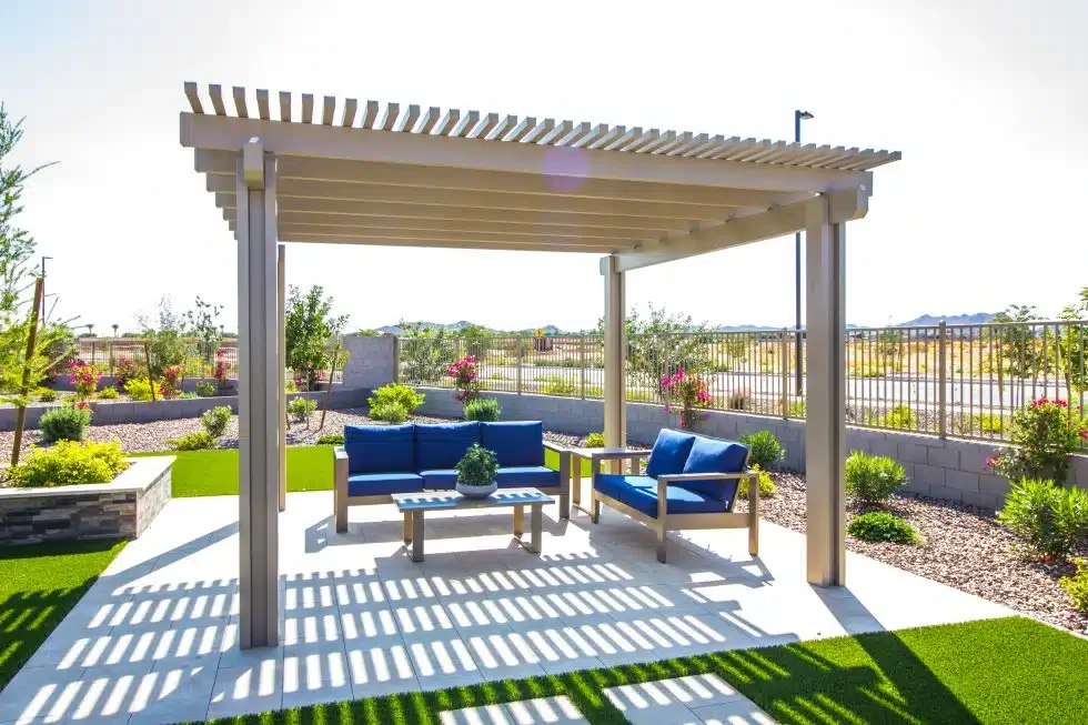 White pergola with outdoor seating over a patio